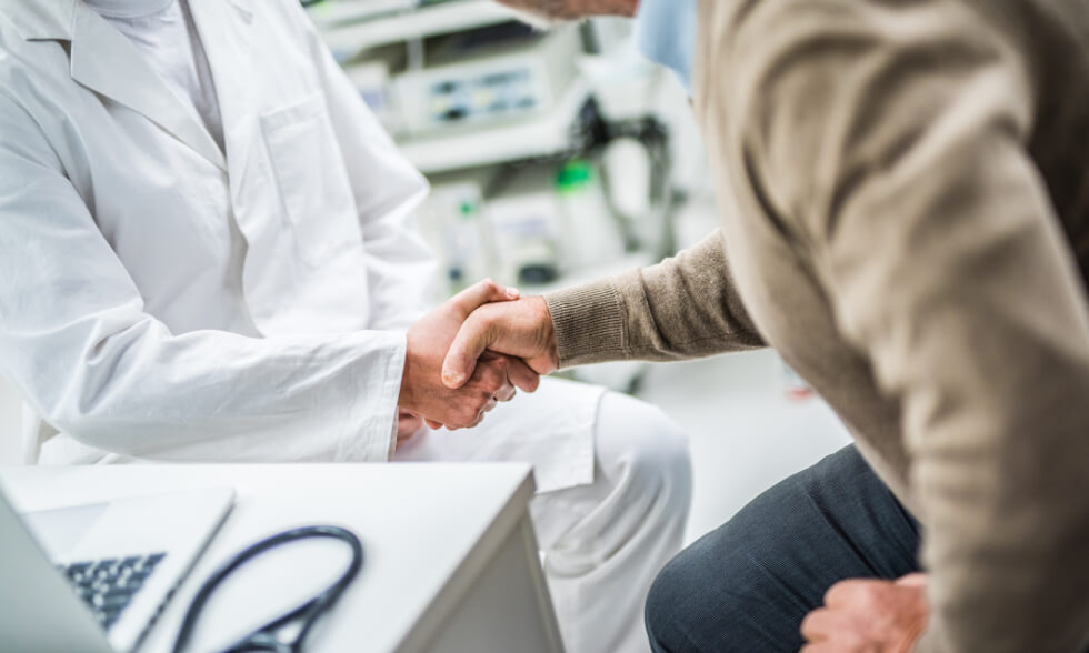 person shaking hand of medical professional